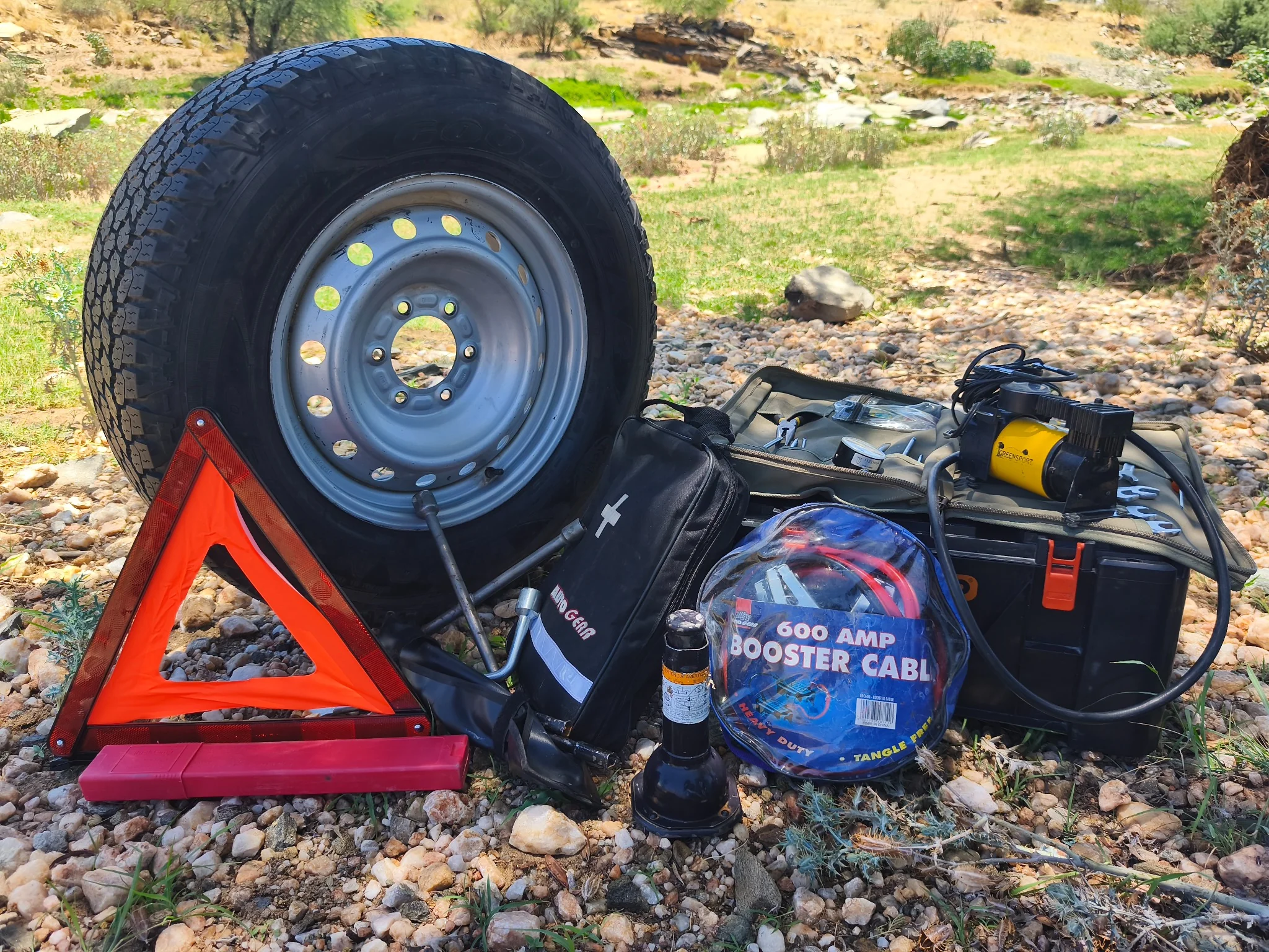 Toyota Hilux Camping emergency and roadside equipment including spare wheel, air compressor, jumper cables, first aid kit and warning triangle